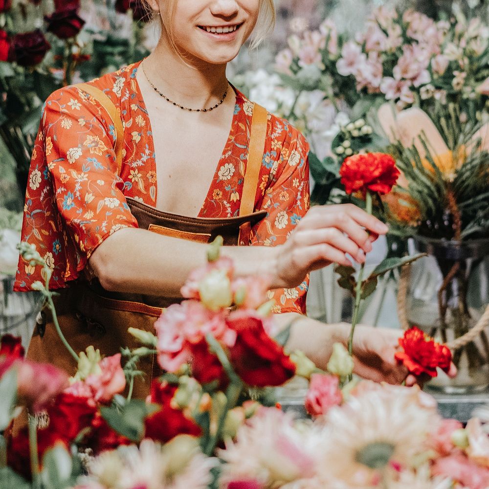 Florist arranging Paeonia peter brand in her shop