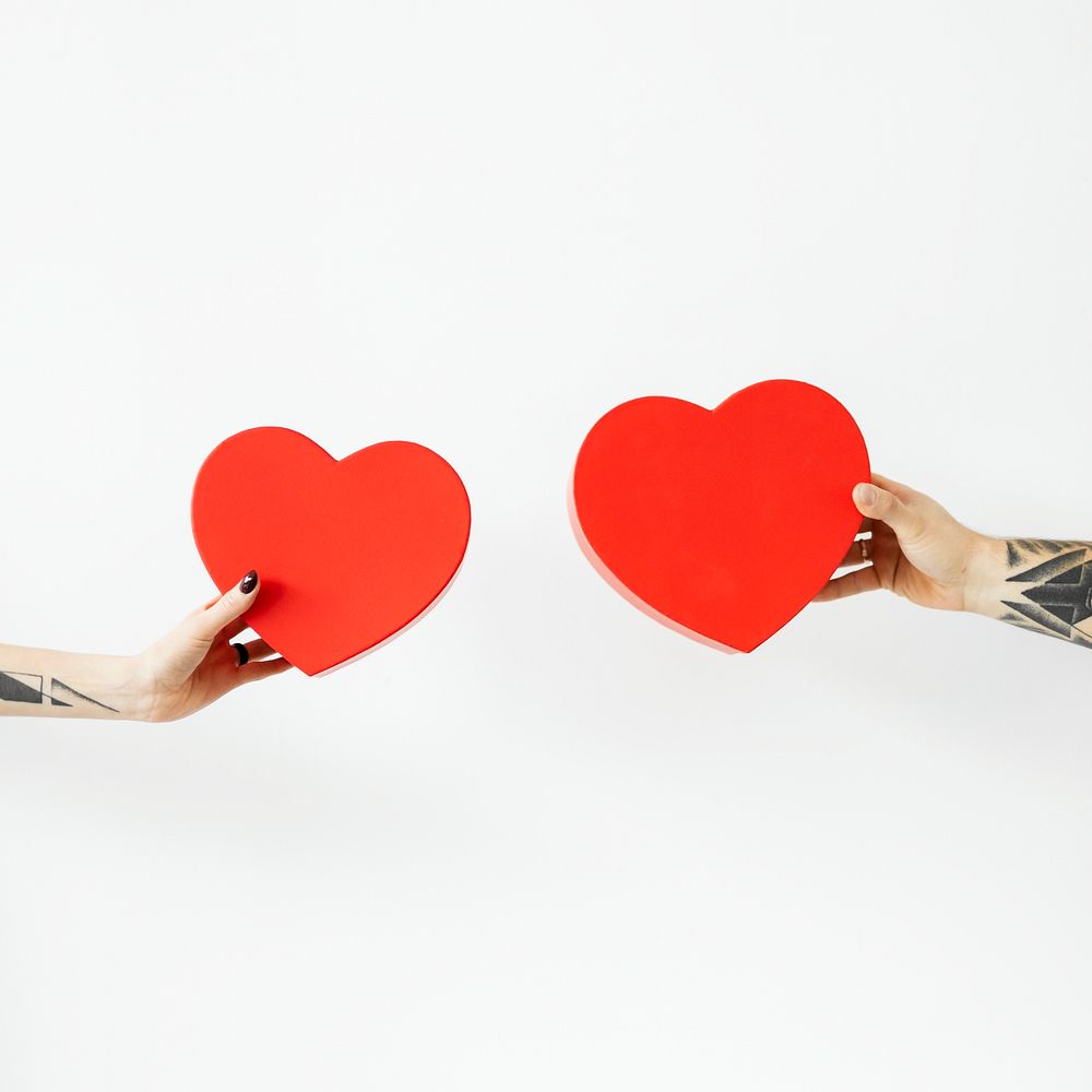 Tattooed hands holding red hearts social ads template 