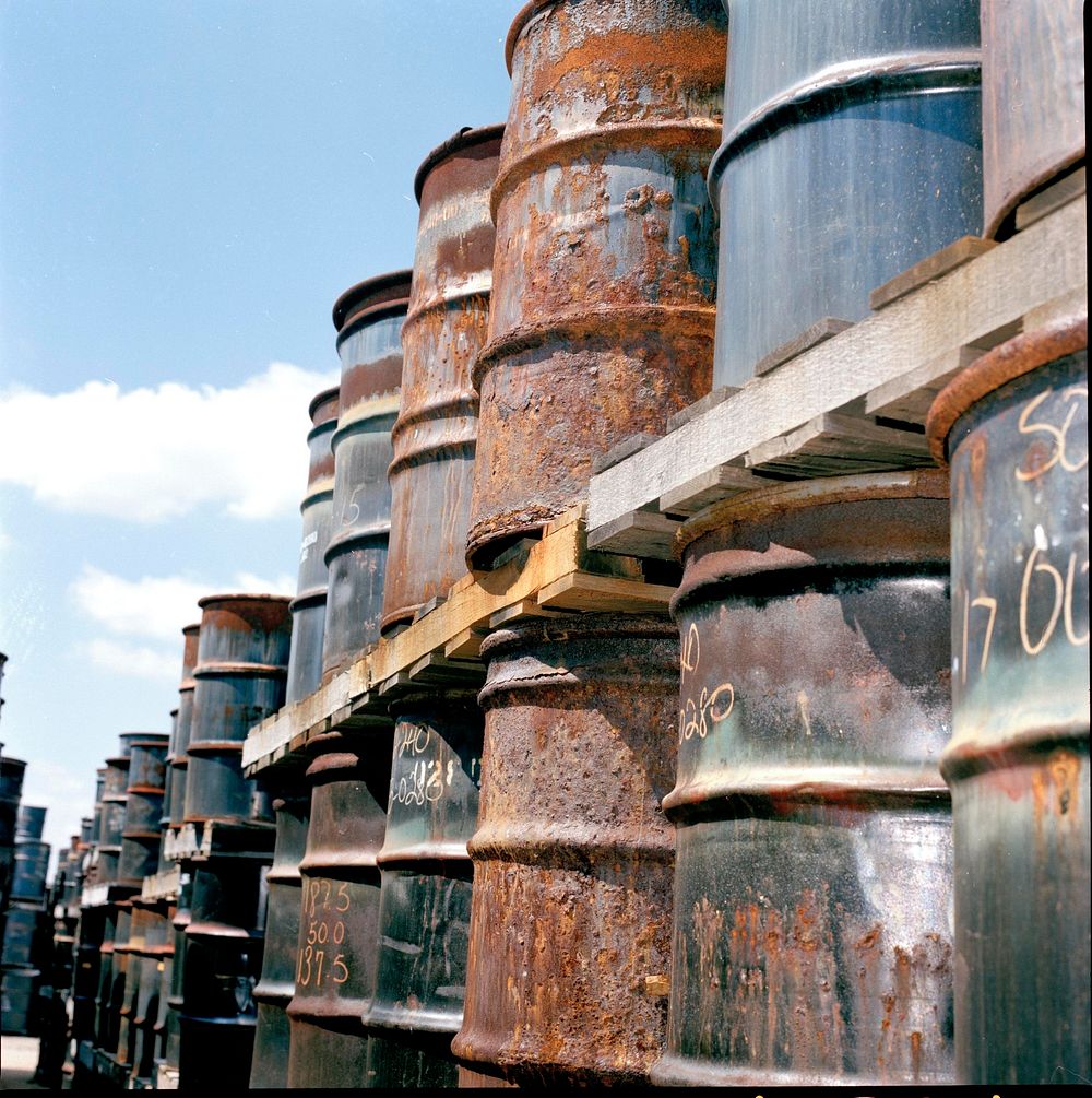 Rusted drums requiring re-packaging on the plant 1 pad. Original public domain image from Flickr