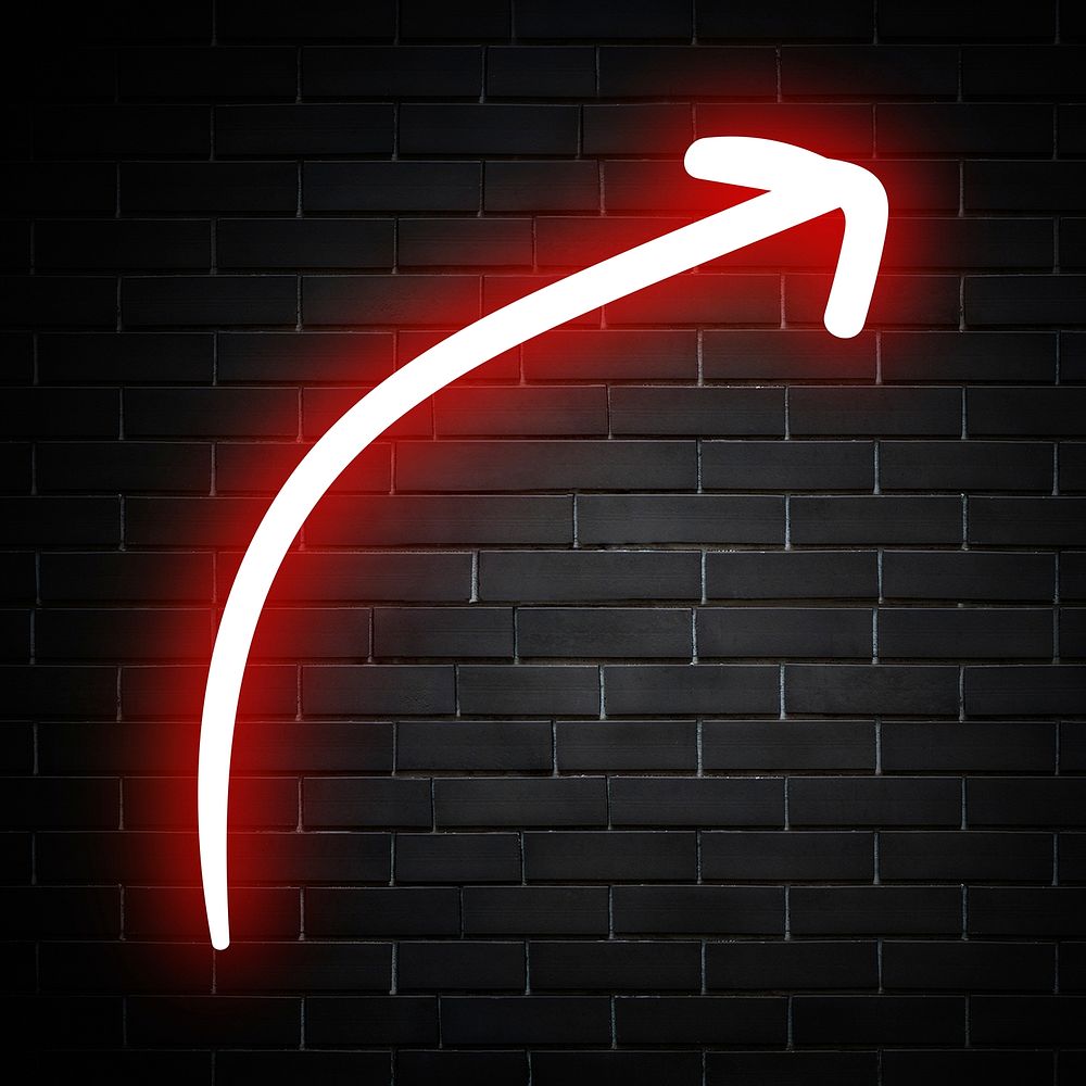 Neon red curved arrow sign on brick wall