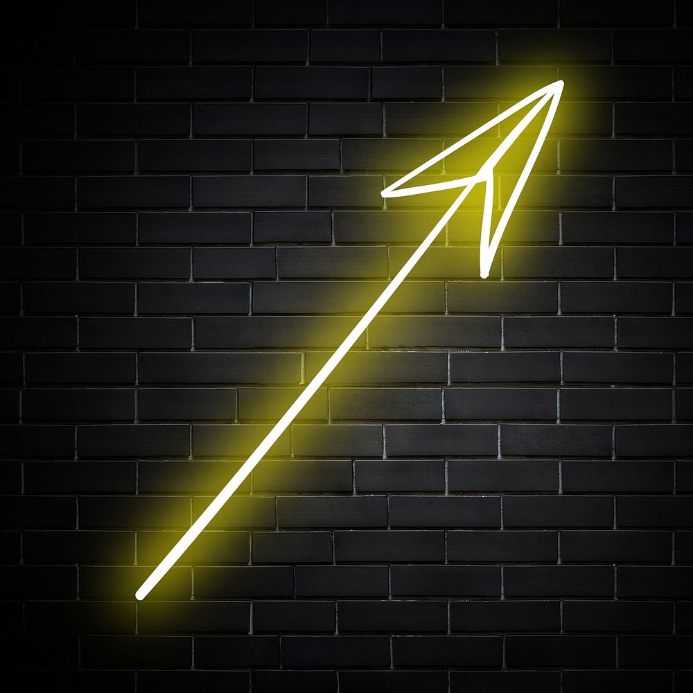 Neon yellow straight arrow sign on brick wall