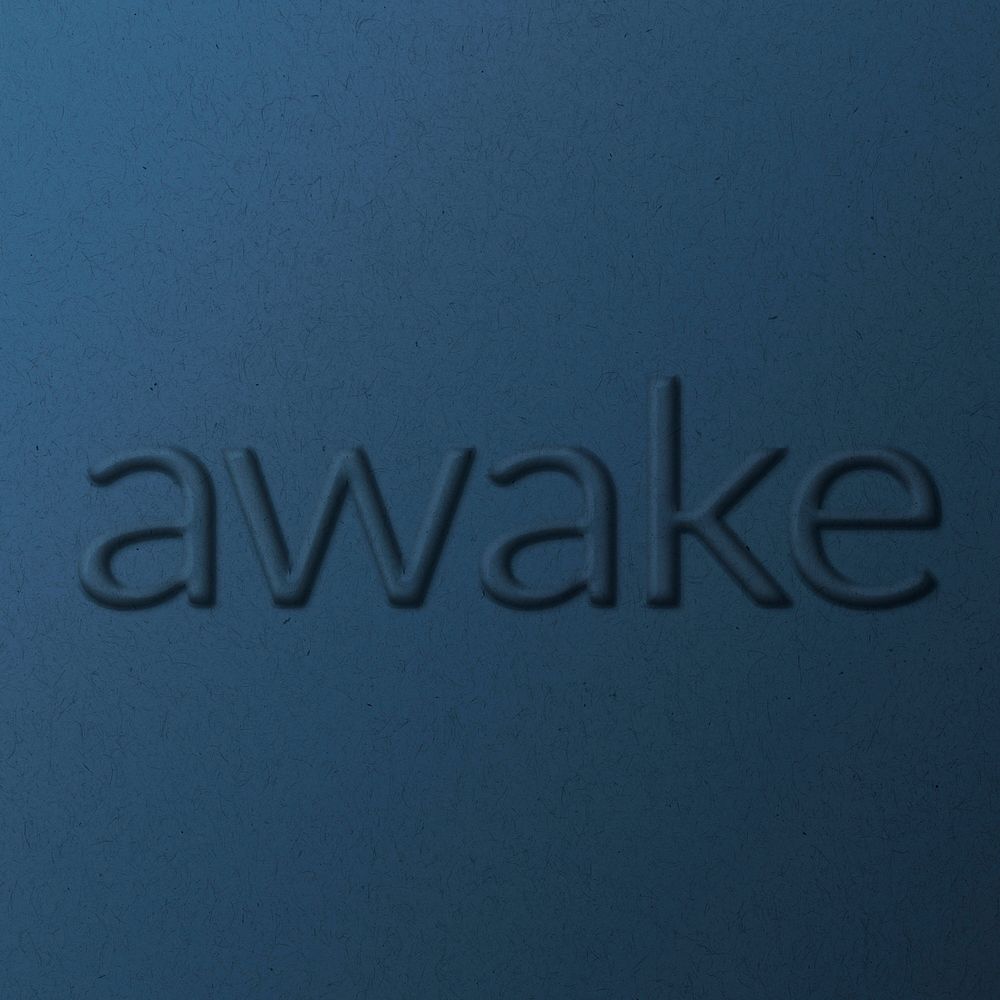 Word awake embossed typography on paper texture
