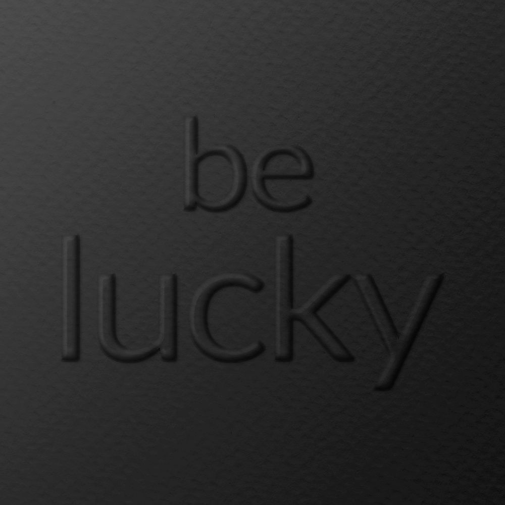 Be lucky emboss typography on paper texture