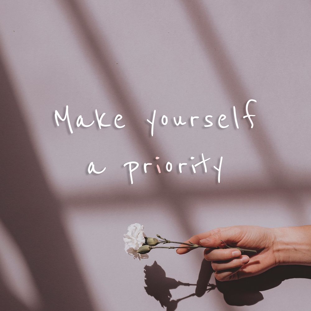 Make yourself a priorty quote on a hand holding flower background