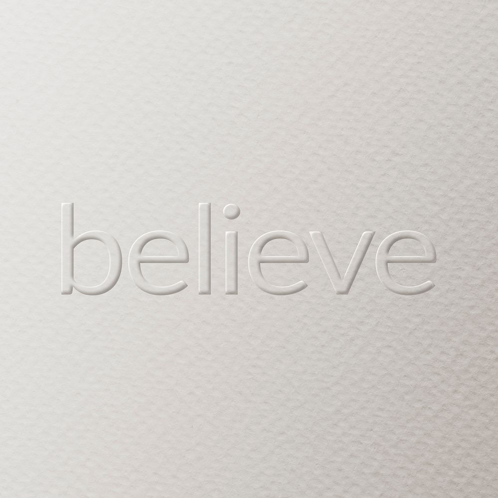 Believe embossed text white paper background