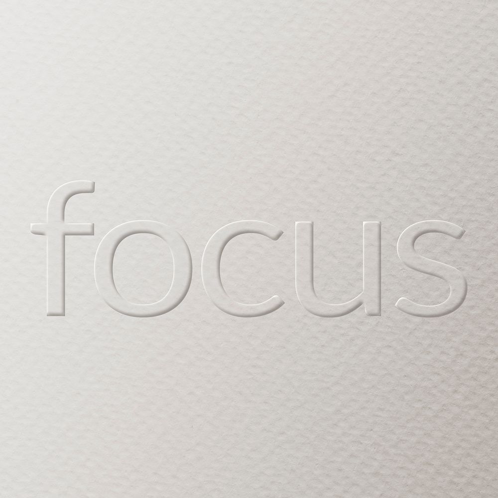Focus embossed font white paper background