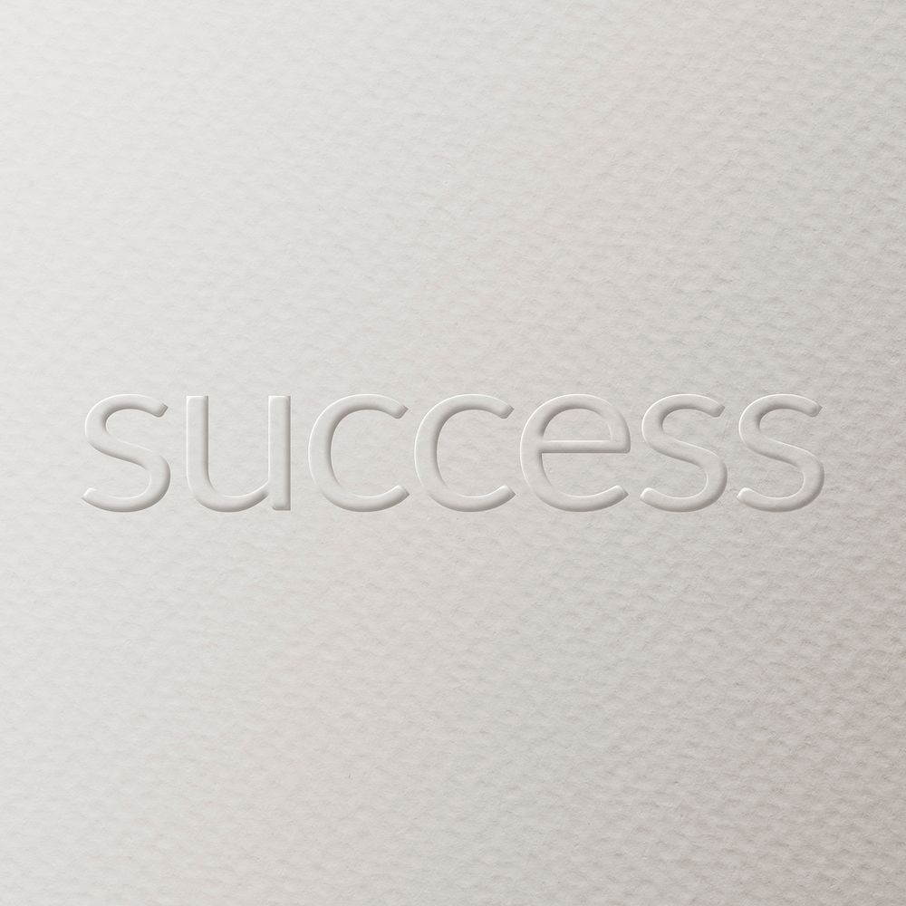 Success embossed text white paper background