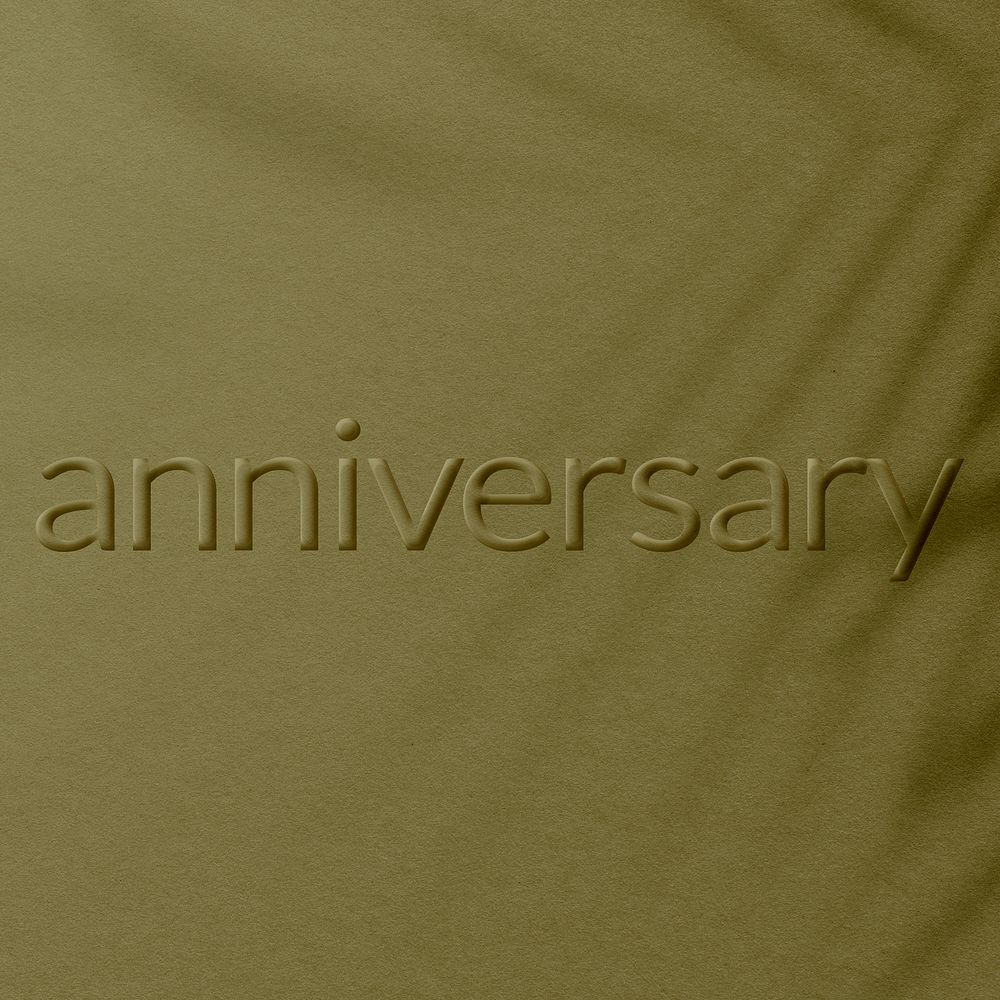 Anniversary word embossed concrete texture shadow plant