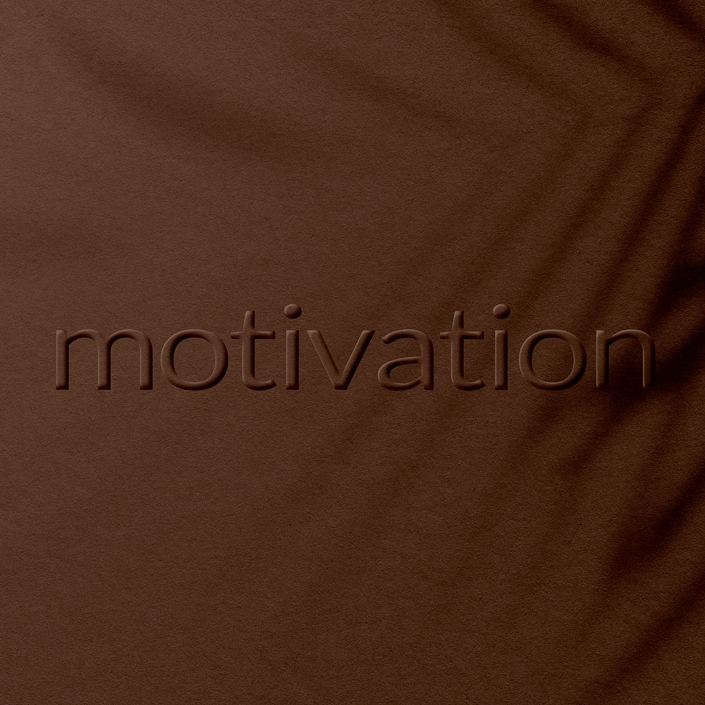 Brown motivation text embossed textured concrete font