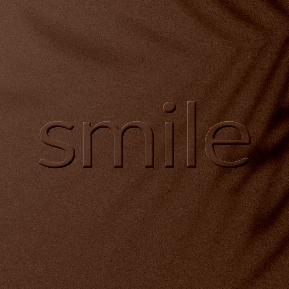 Embossed smile word concrete textured typography