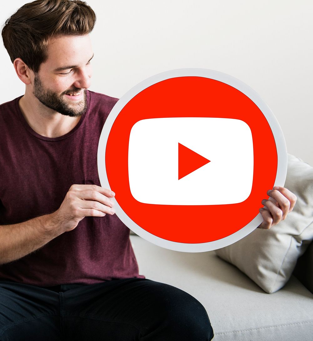 Person holding a YouTube icon