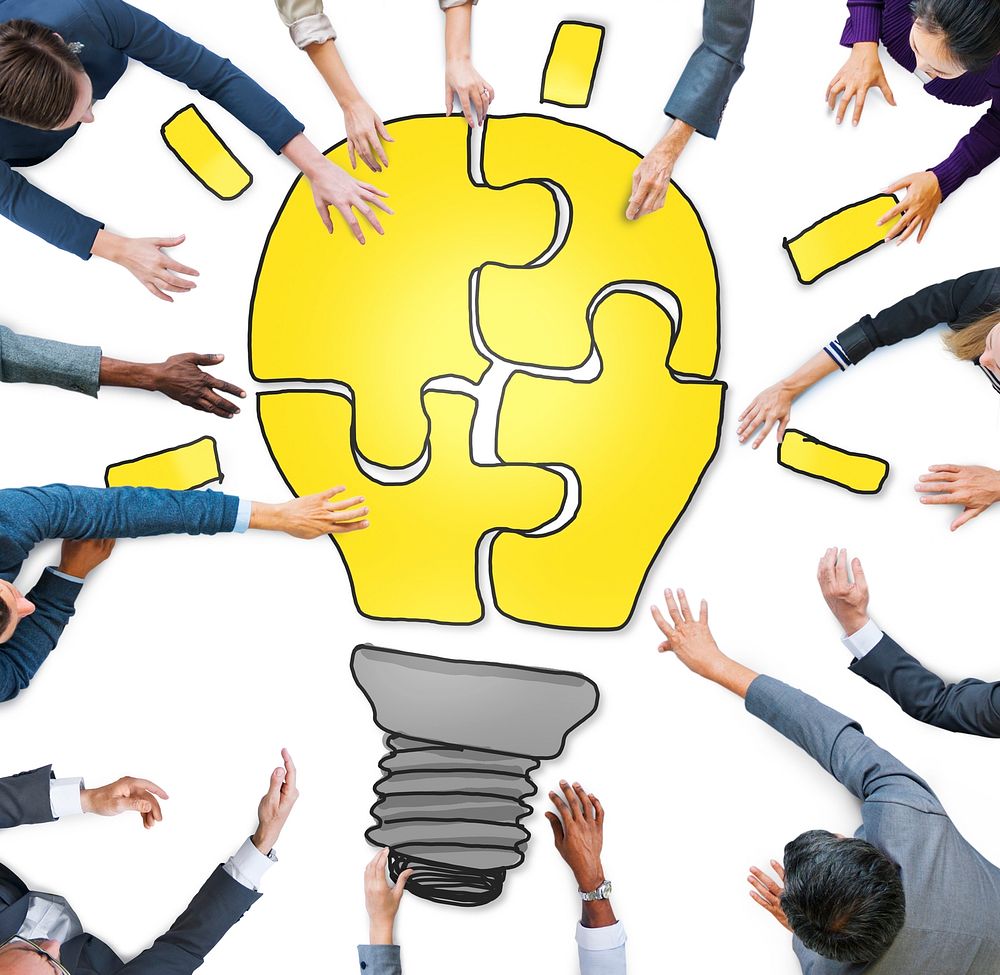 Business People Forming a Light Bulb Puzzle