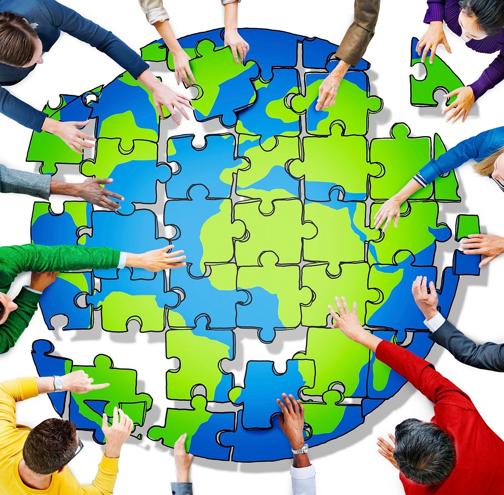 People with Jigsaw Puzzle Forming Globe in Photo and Illustration