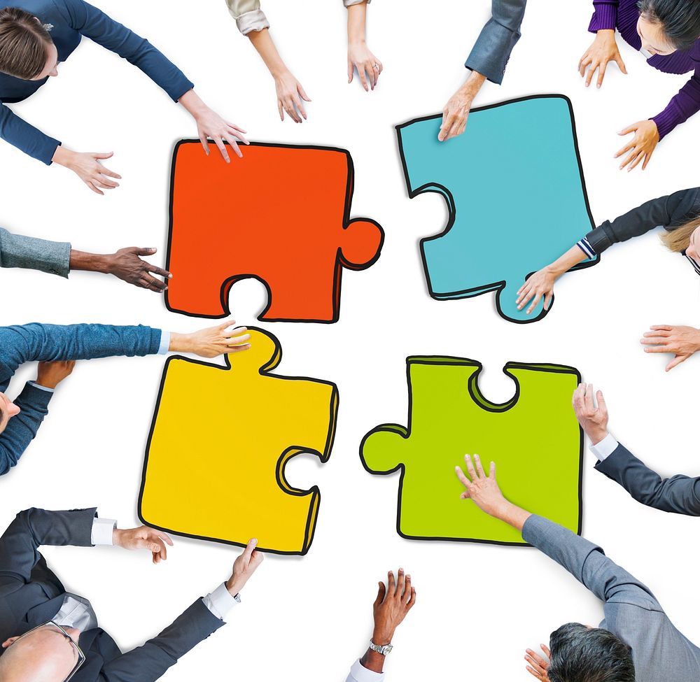 Group of People Holding Jigsaw Puzzle in Photo and Illustration