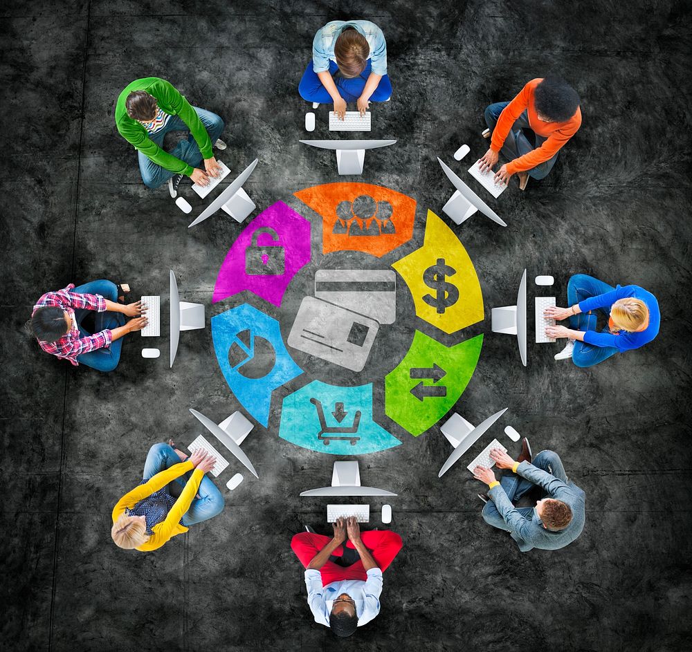 People in a Circle Using Computer with Financial Concept