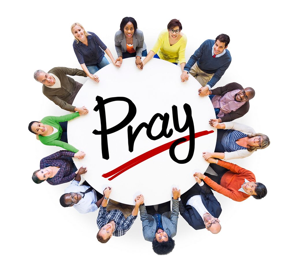 Group of People Holding Hands Around Letter Pray