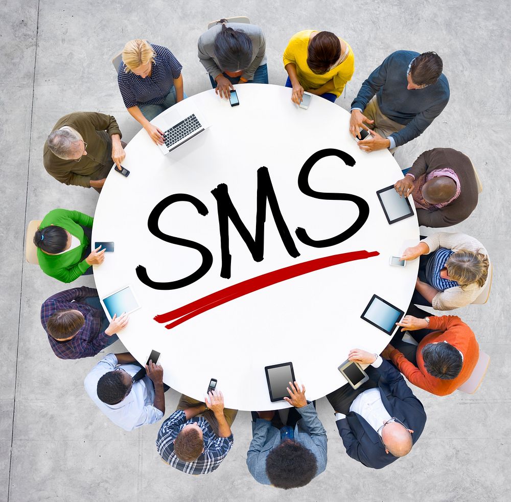 Group of People Holding Hands Around Letter SMS