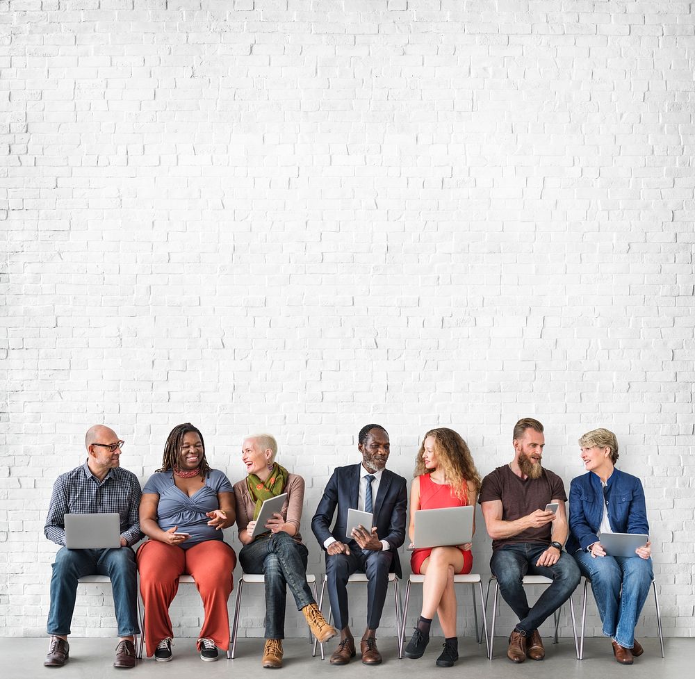 Diverse Group of People Community Togetherness Technology Sitting Concept