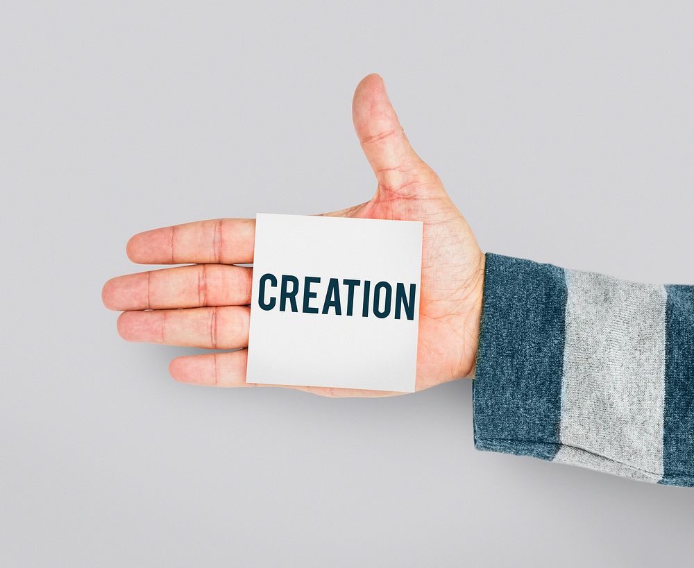 Hand with Sticky Note Showing Creative Ideas Design Word