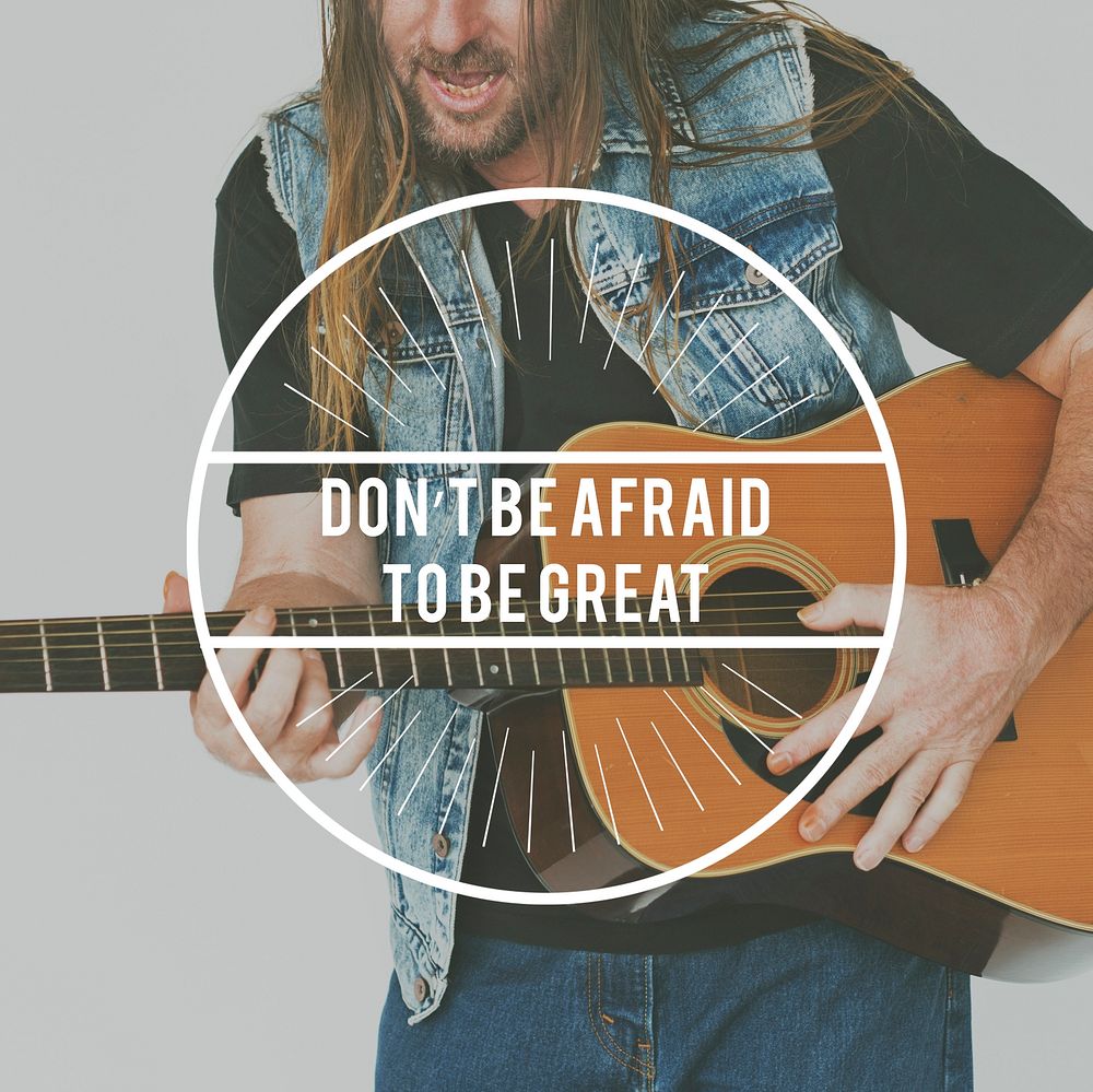 Dont Afraid To Be Great Word on Man Playing Guitar Background