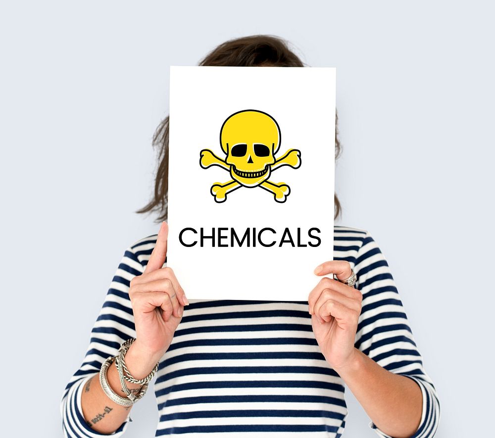 People holding placard with skull icon and chemicals dangerous