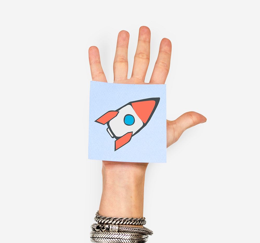 Hand holding note with rocket start up icon