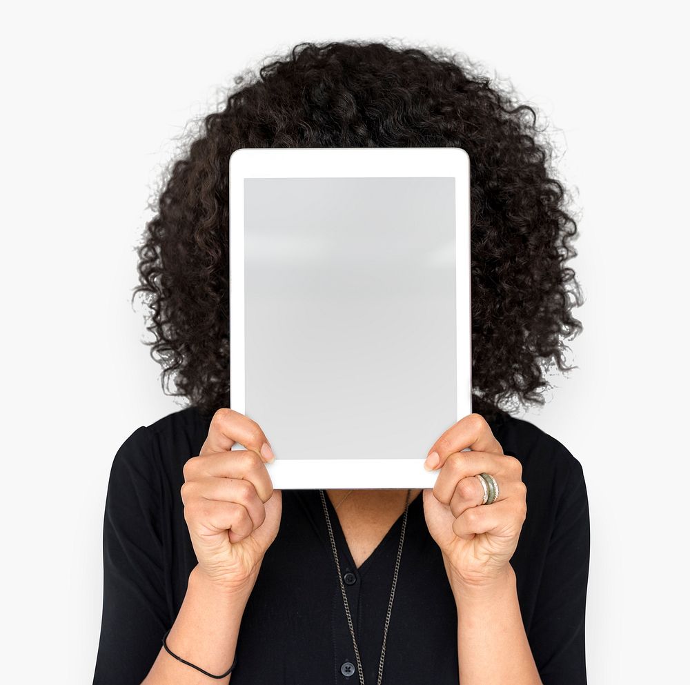 Woman holding tablet covering her face