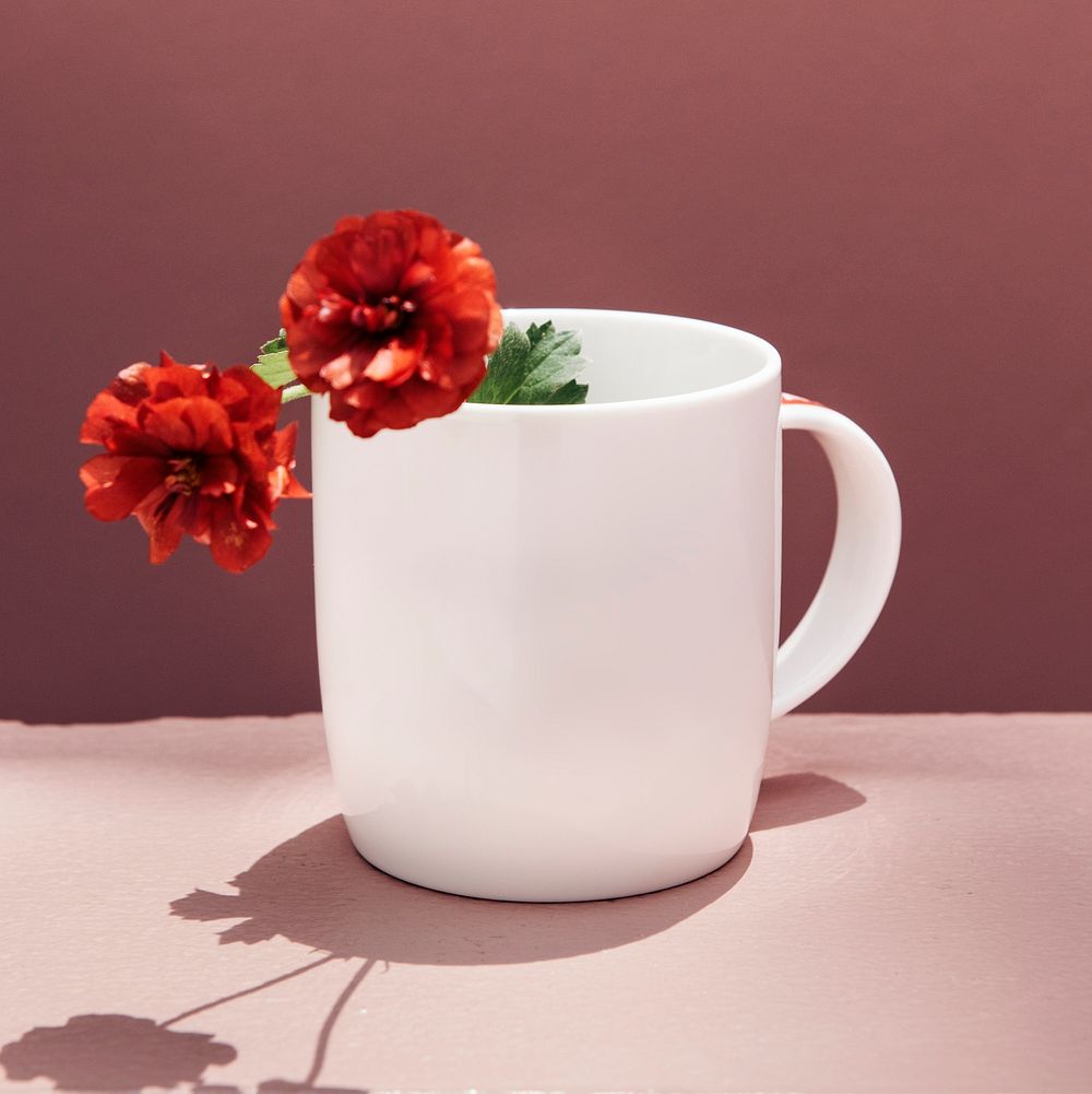 Red peonies in a coffee mug
