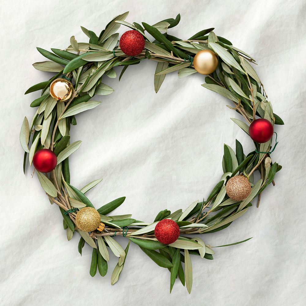 Handmade Christmas wreath decoration on a white fabric background