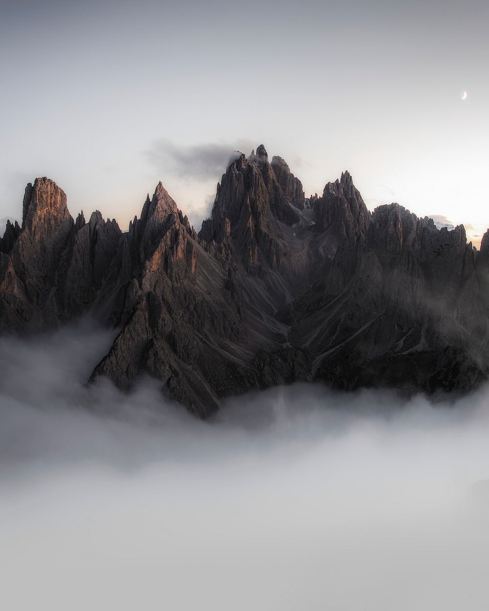 View of foggy Tre Cime di Lavaredo in Dolomites, Italy