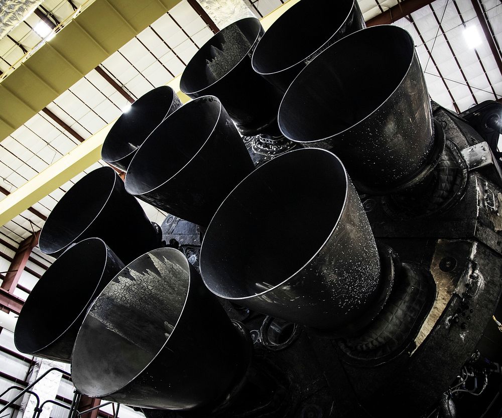 Falcon 9 first stage in hangar; upgraded Merlin engines close-up (2015). Original from Official SpaceX Photos. Digitally…