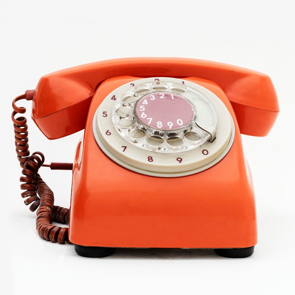 Vintage orange telephone on white background