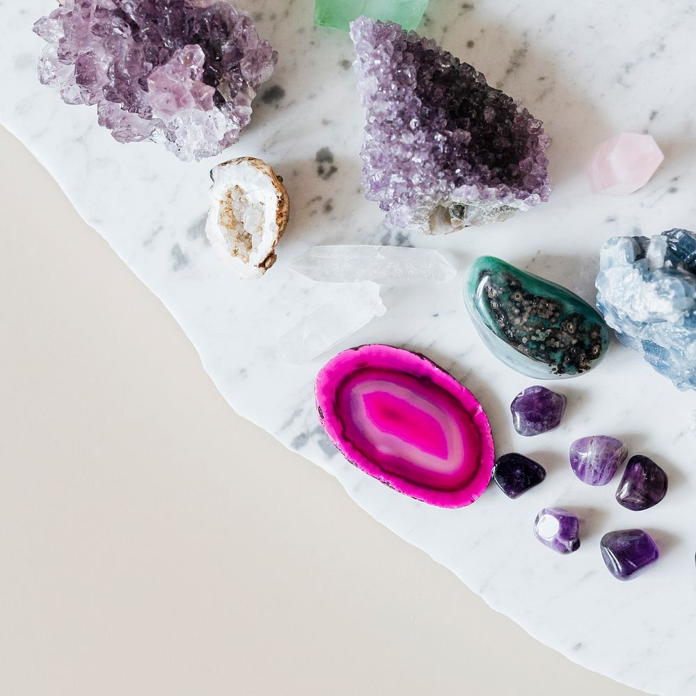 Colorful healing crystals on a marble countertop 