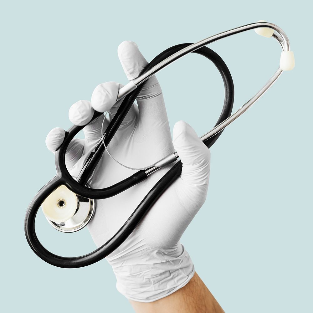 Hand with latex glove holding a stethoscope duting a virus outbreak