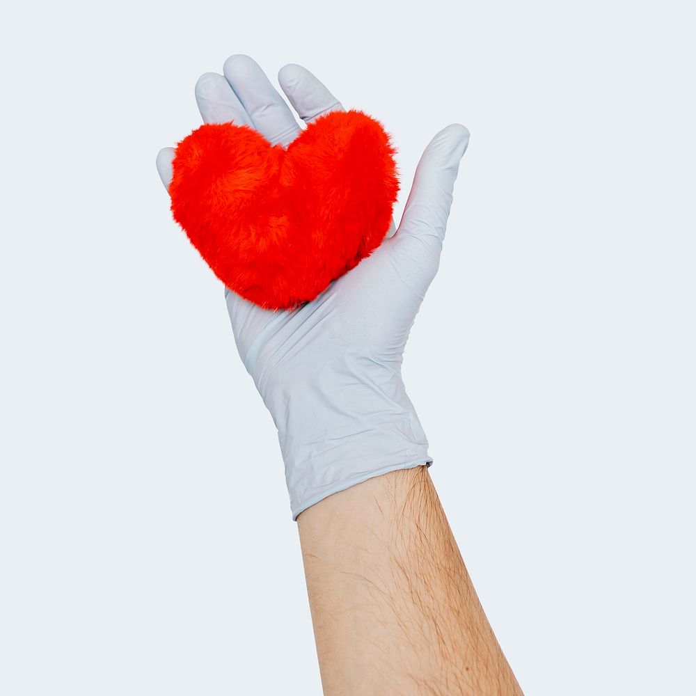 Gloved hand holding a fluffy red heart mockup