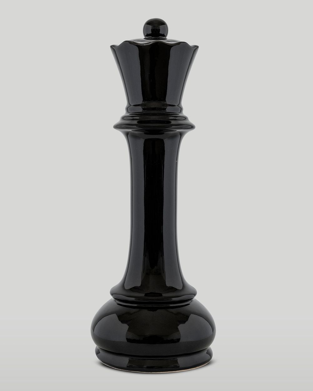 Black queen chess piece on off white background