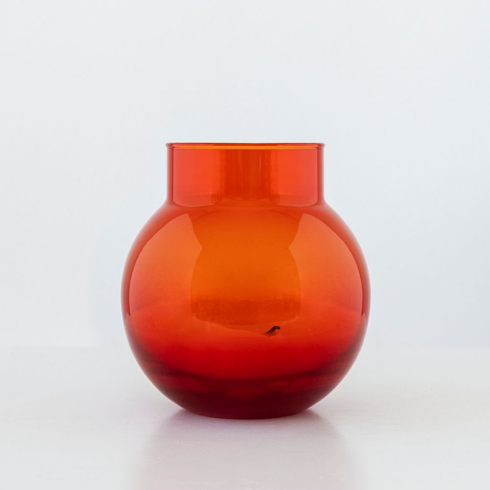 Empty shiny red glass vase on off white backgrounds