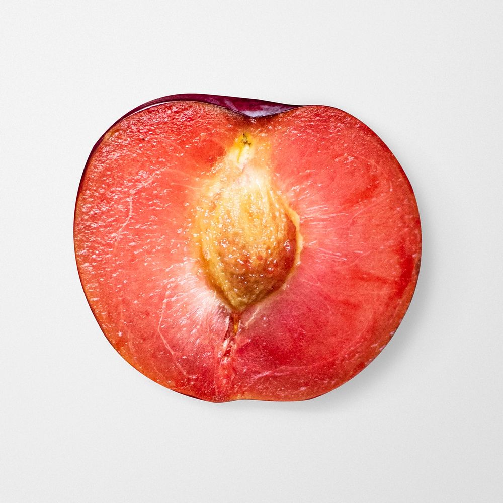 Half ripe red plum with pit psd