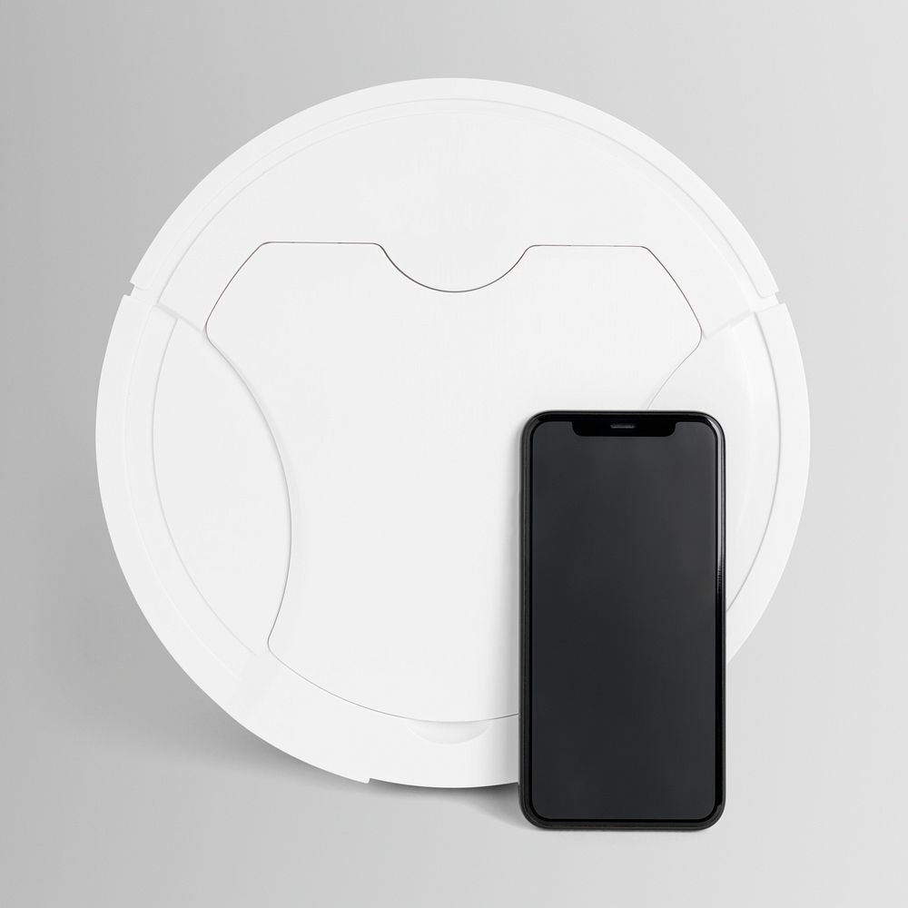 White robot vacuum and smartphone home electronics