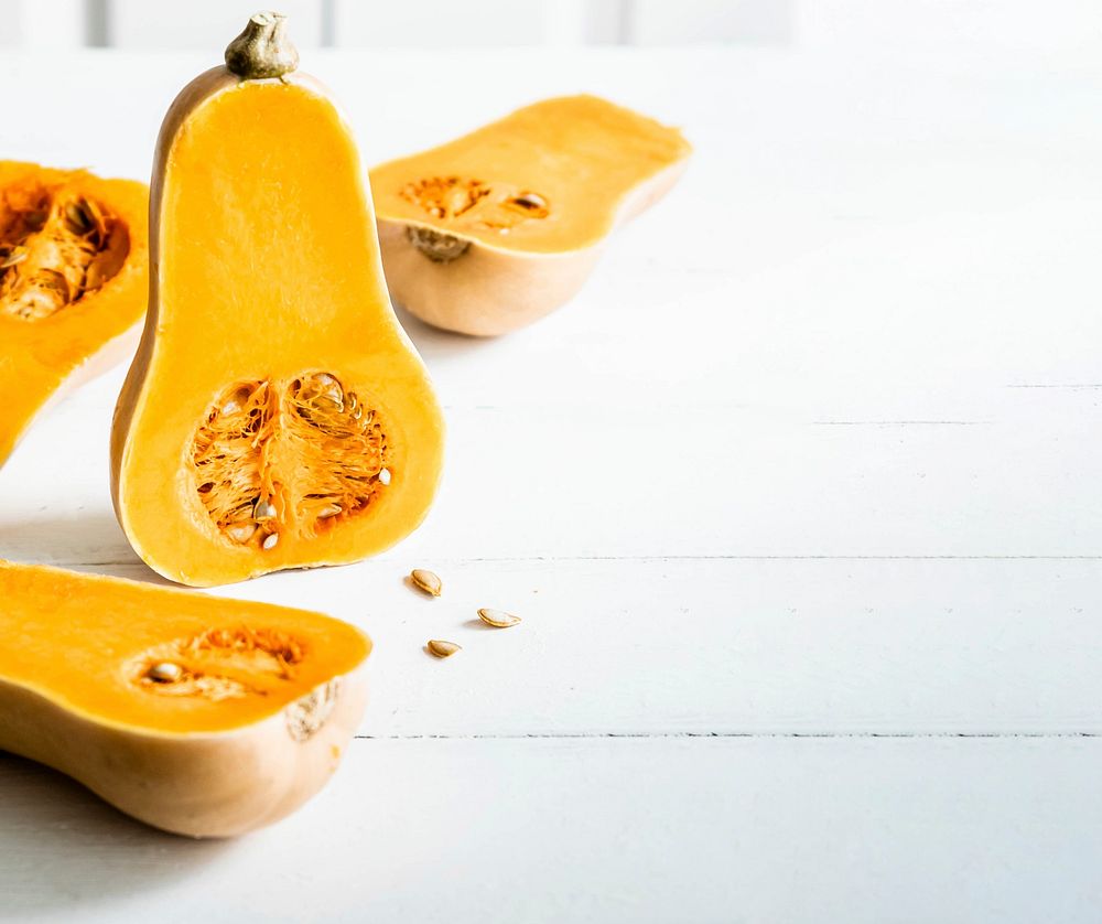 Butternut squash with seeds on white table