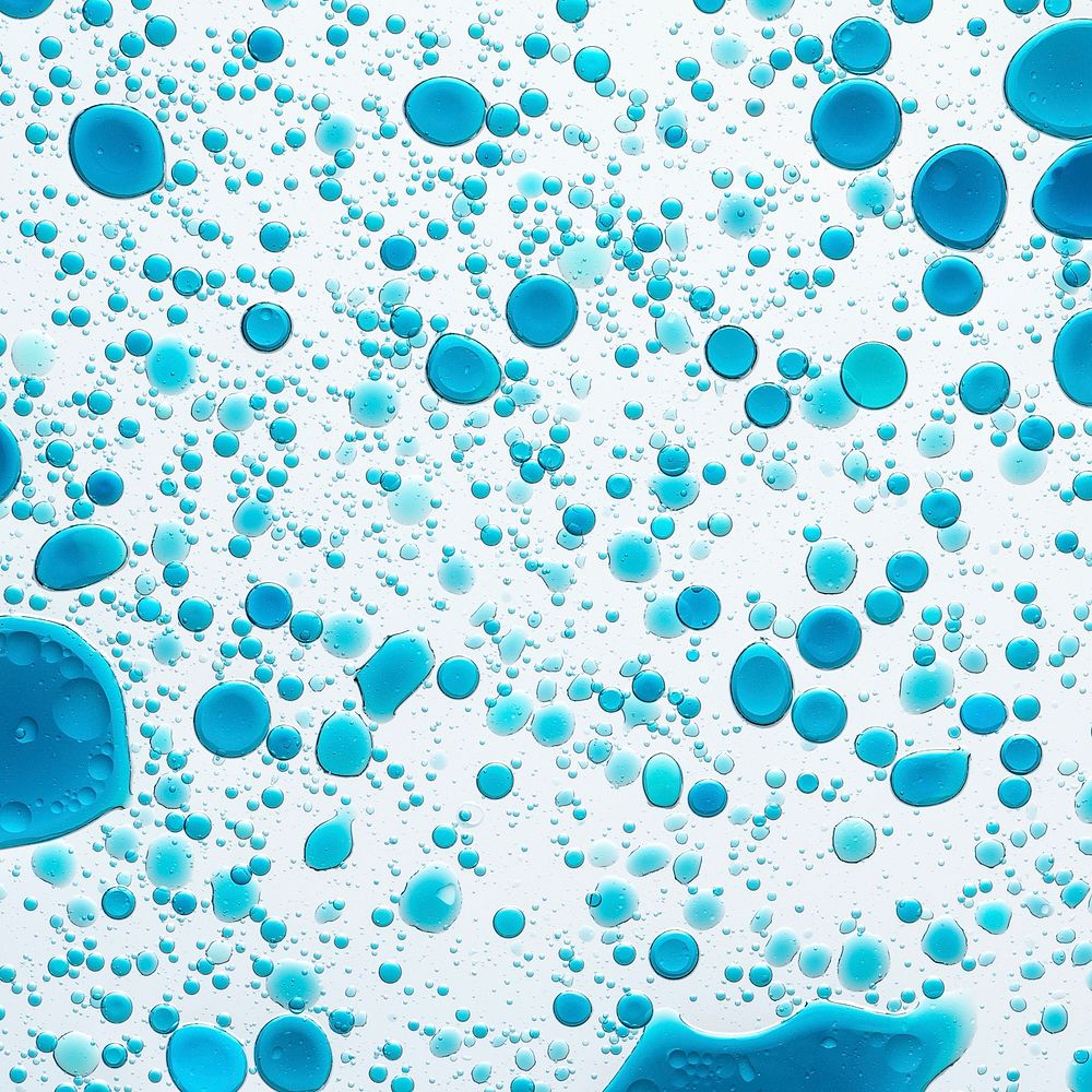 Blue background, oil bubble in water