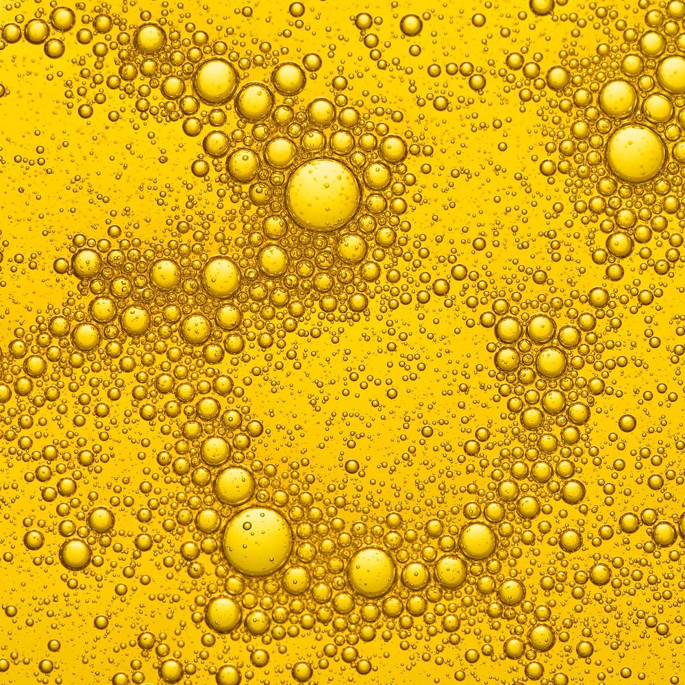Gold background, oil bubble in water beer