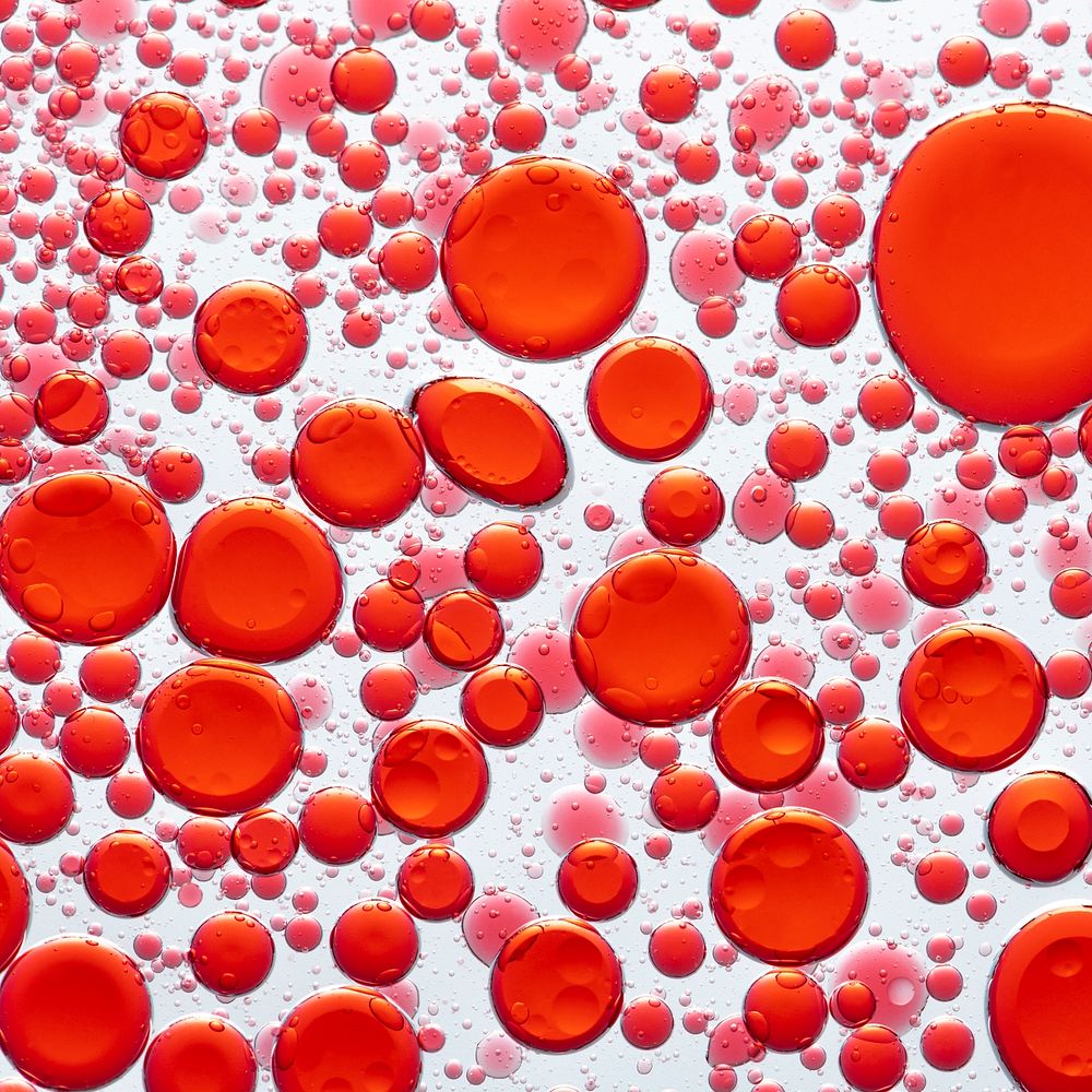 Red background, abstract oil bubble in water