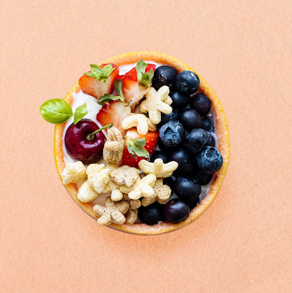 Kids breakfast cereal bowl with berries and yogurt