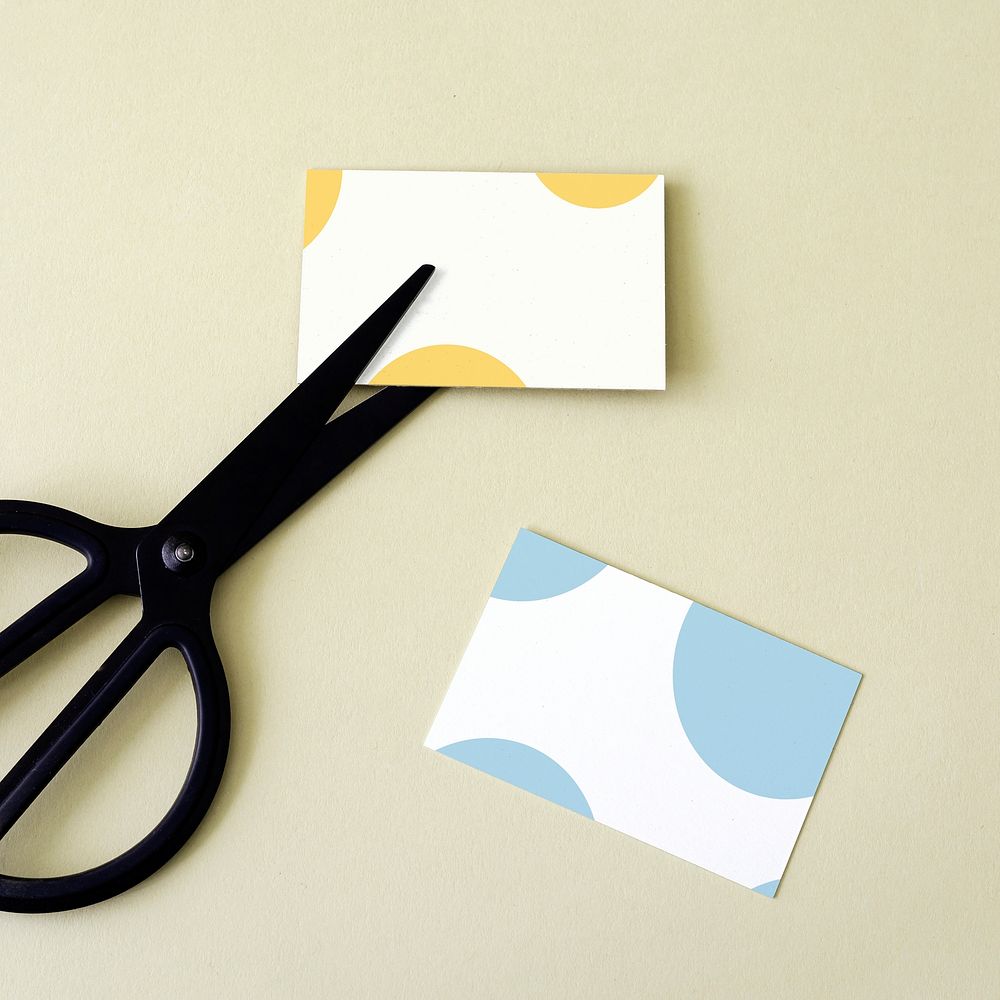 Blank personal card and black scissors