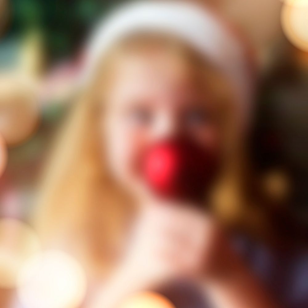 Blurry little blond girl enjoying Christmas time