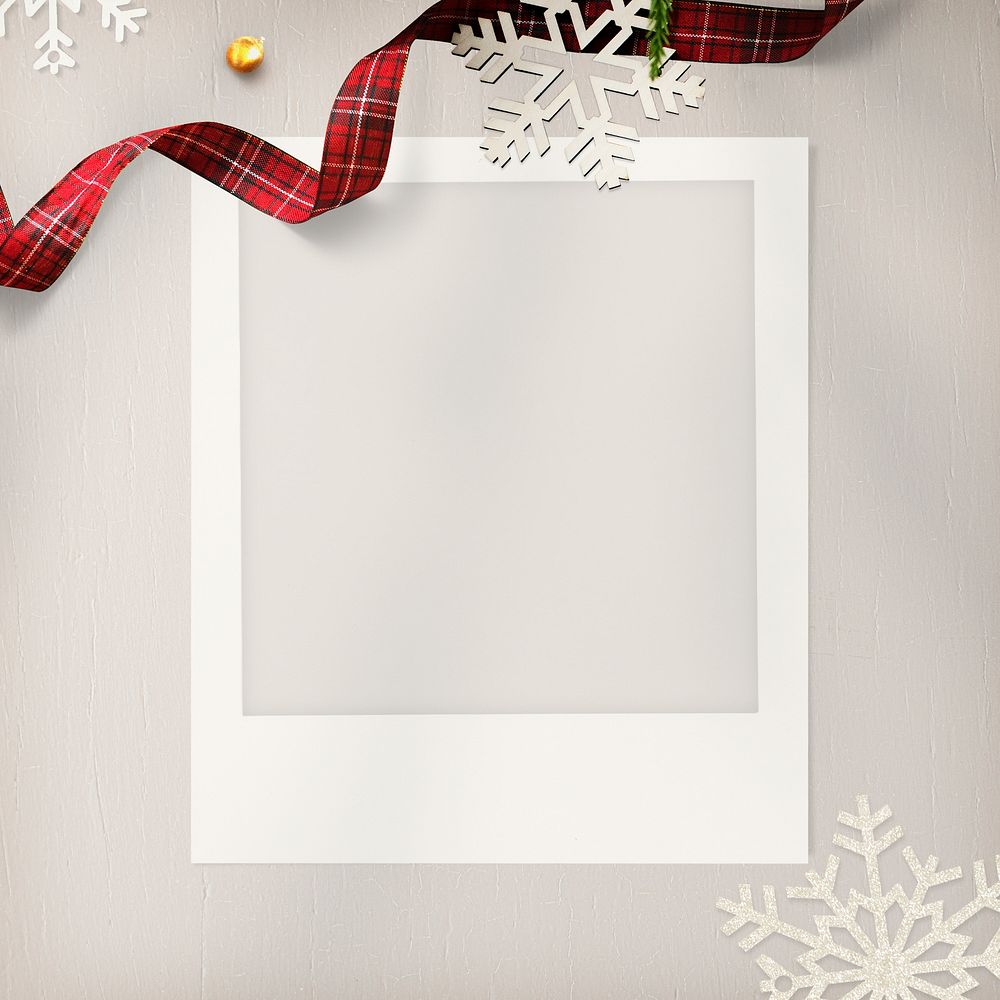 Blank photo frame with Christmas decorations on cream background