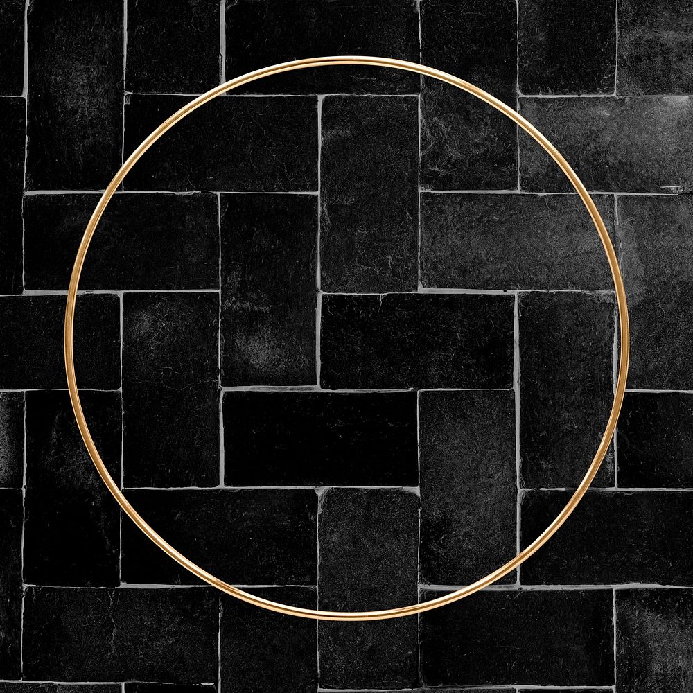 Round gold frame on a black brick patterned background