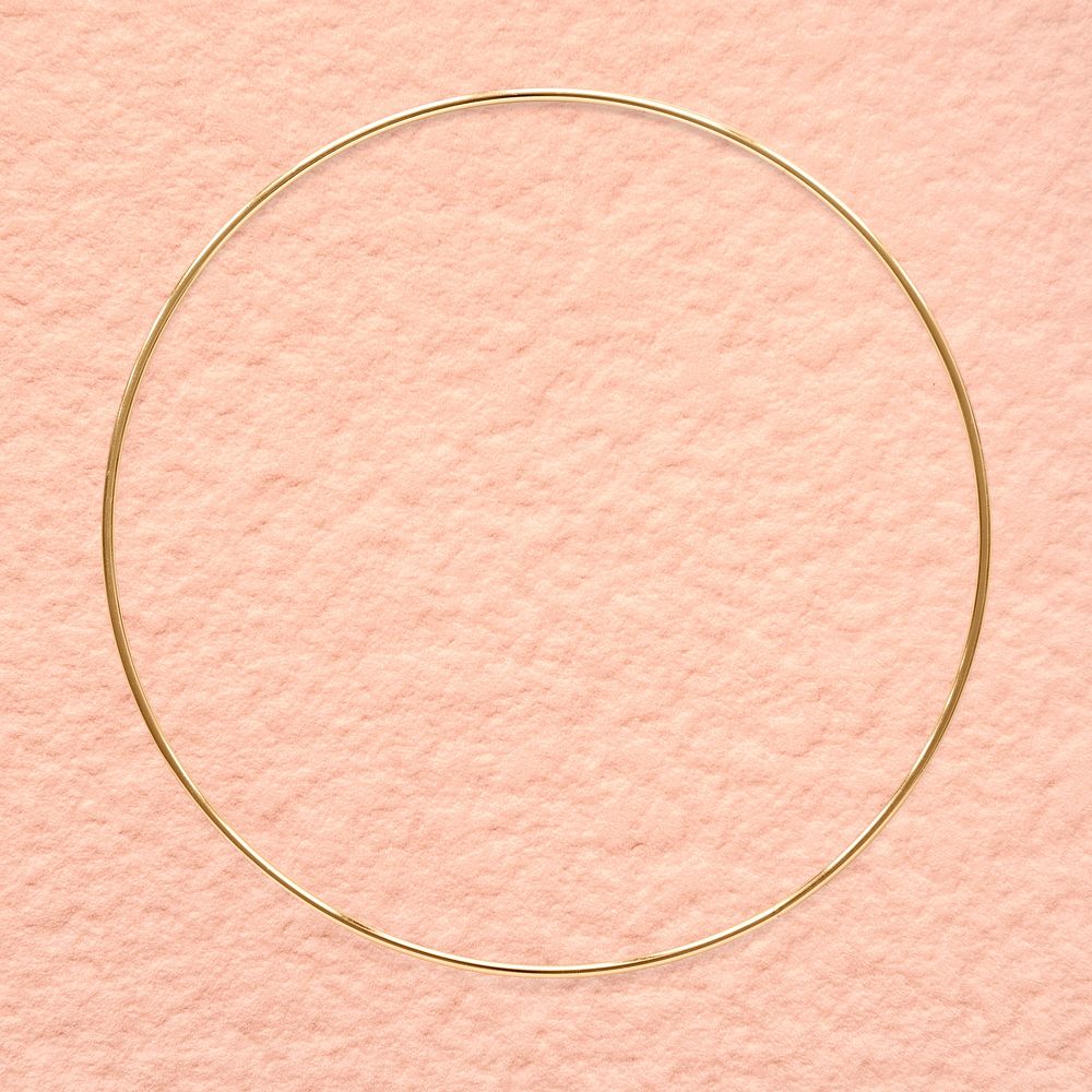 Round gold frame on an old rose pink background