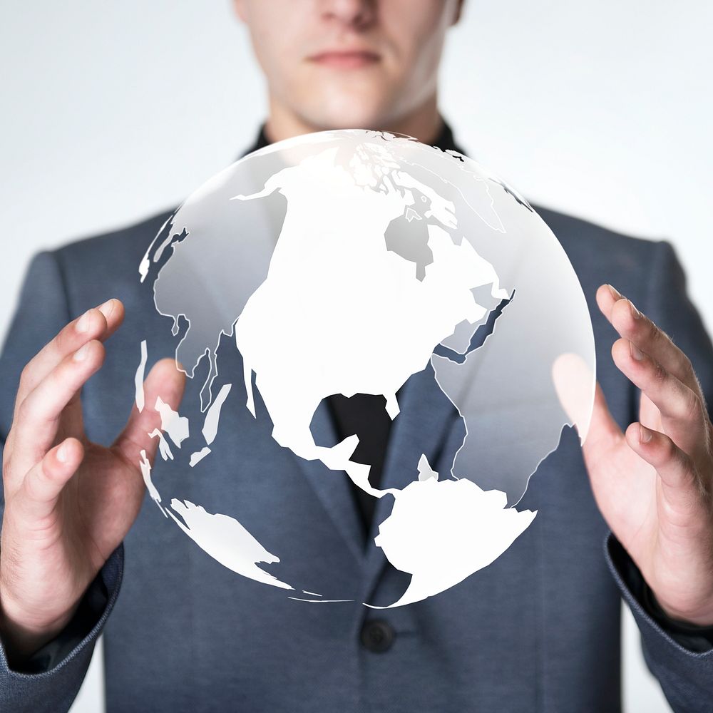 Businessman holding a digitally generated globe 